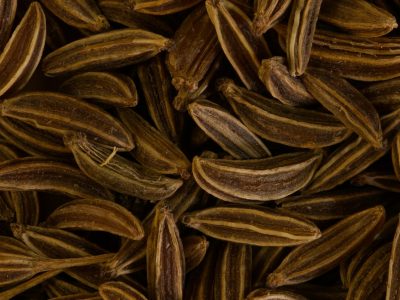 Detailed close-up of brown caraway seeds, ideal for spice and culinary themes. Perfect for food-related content.