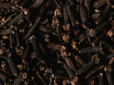 Close-up view of aromatic dried cloves, showcasing texture and rich brown color.